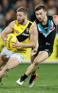 AFL 2017 Round 15 - Port Adelaide v Richmond ADELAIDE, AUSTRALIA - JULY 01: Kane Lambert of the Tigers is tackled by Sam Gray of the Power during the 2017 AFL round 15 match between the Port Adelaide Power and the Richmond Tigers at Adelaide Oval on July 01, 2017 in Adelaide, Australia. (Photo by Michael Willson/AFL Media)